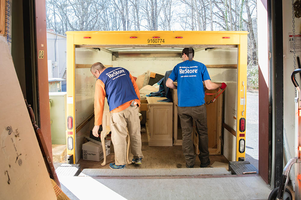 Volunteers unloading a trailer of donated items