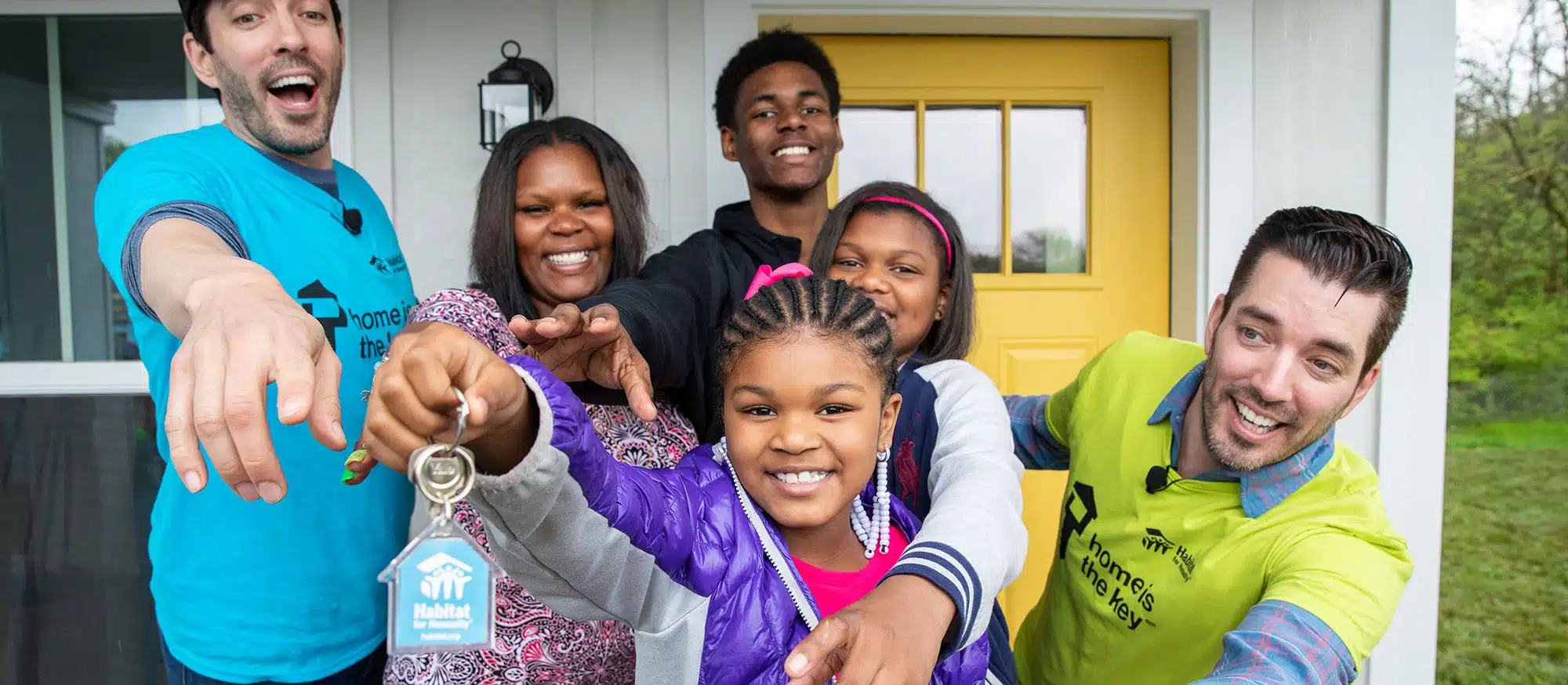 Family holding up new house keys