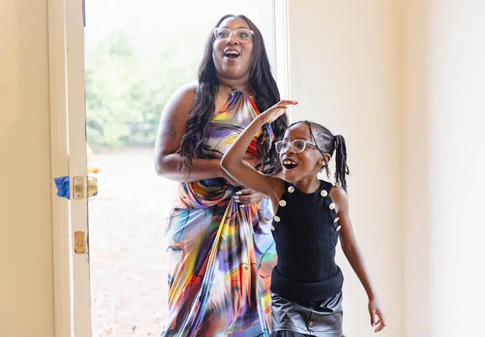 Mom and daughter walking in their new home for the first time